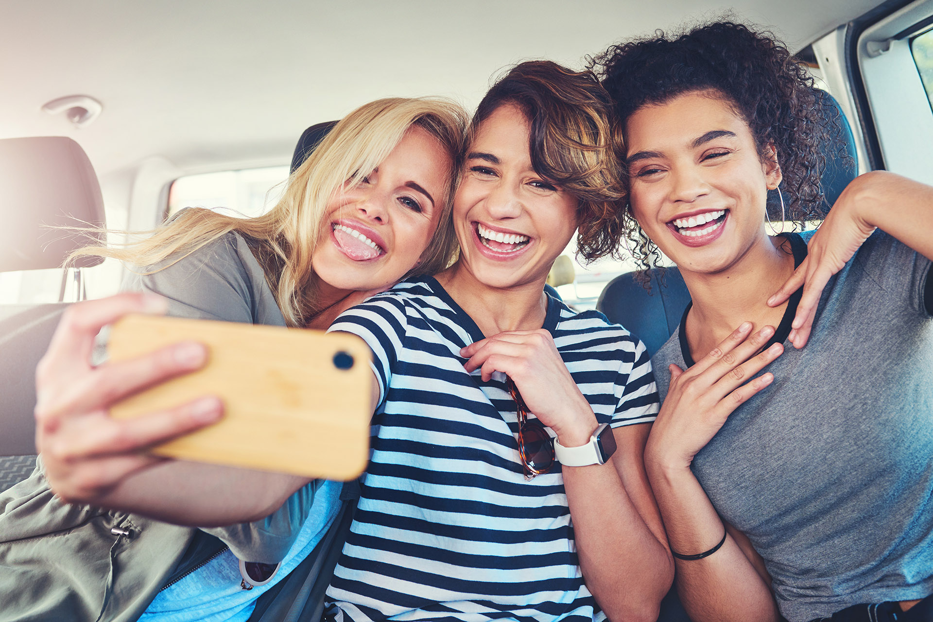 These are the moments we cherish the most. young women taking a selfie while out on a road trip together.