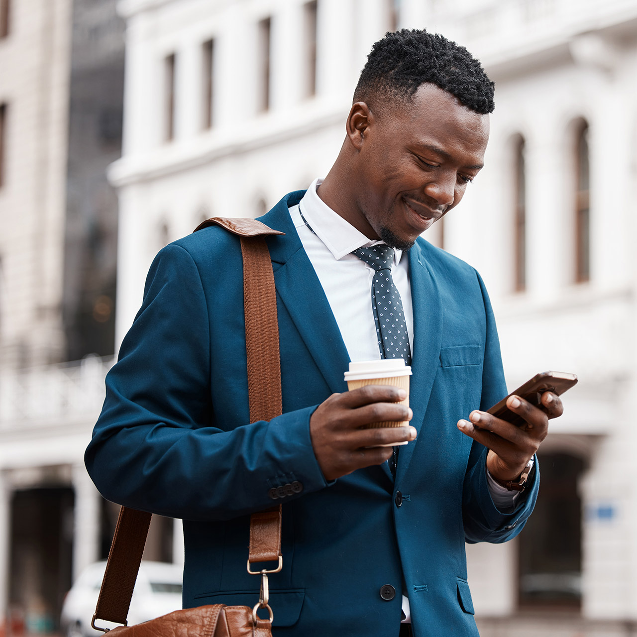 There is no such thing as too much work. a content businessman using his smartphone to send a text while in the city.